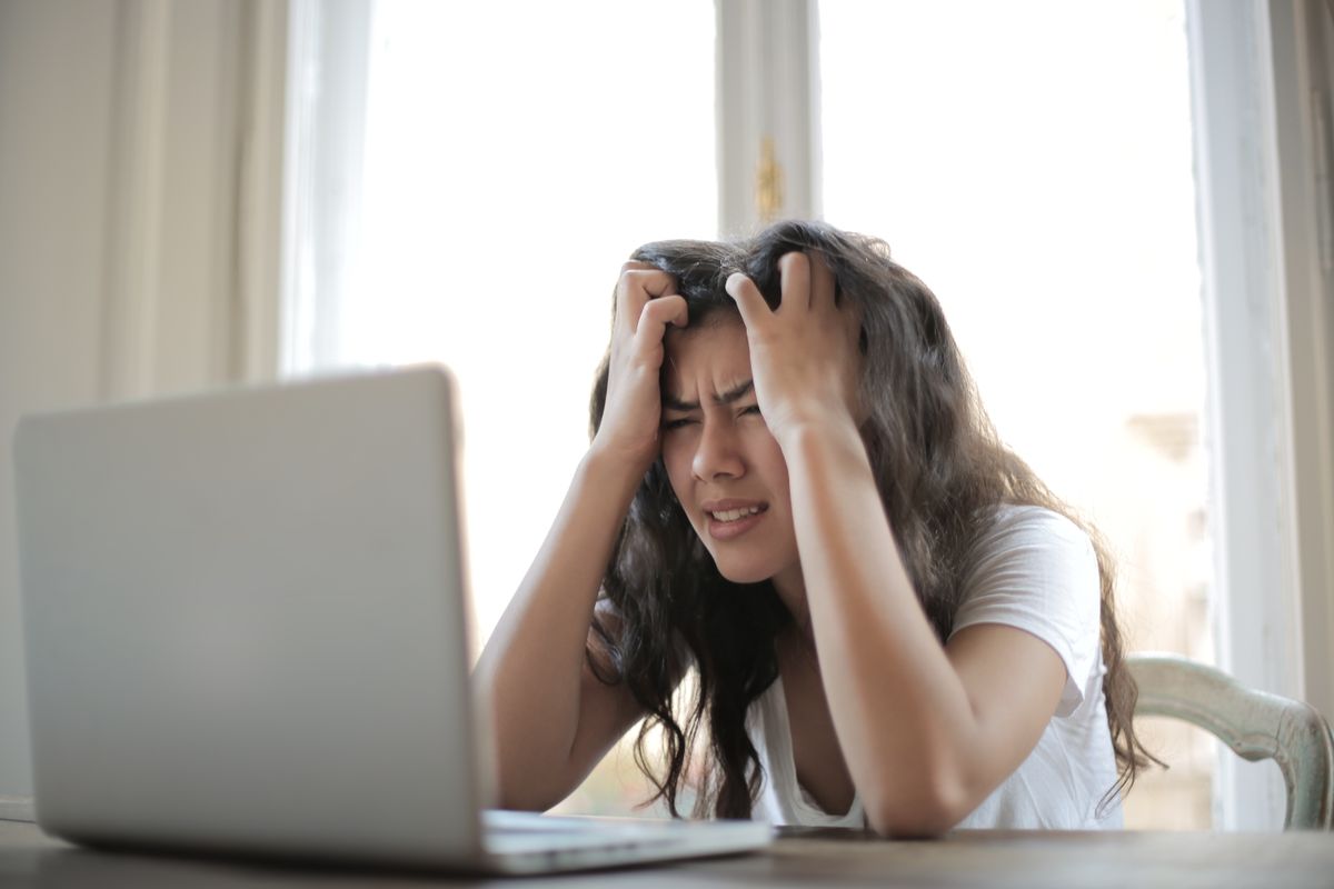 Person writing in a notebook at a desk